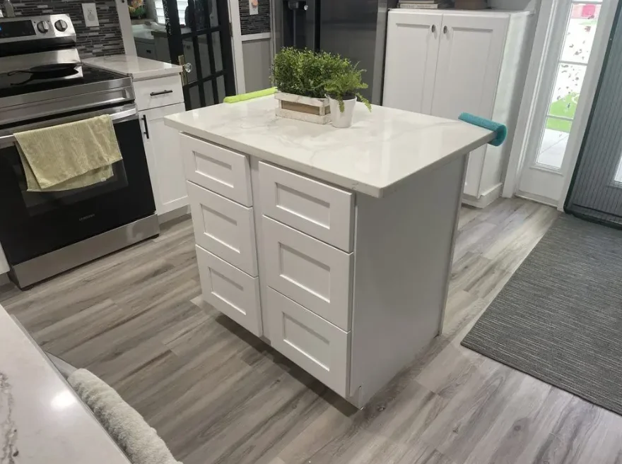 White kitchen island with marble countertop and drawers in modern kitchen display